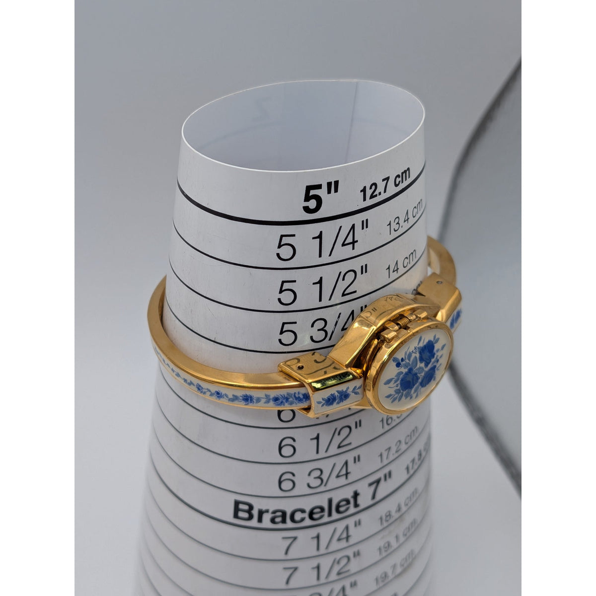 Andre Mouche Gold Tone Bangle Peekaboo Watch White Enamel Deep Blue Flowers