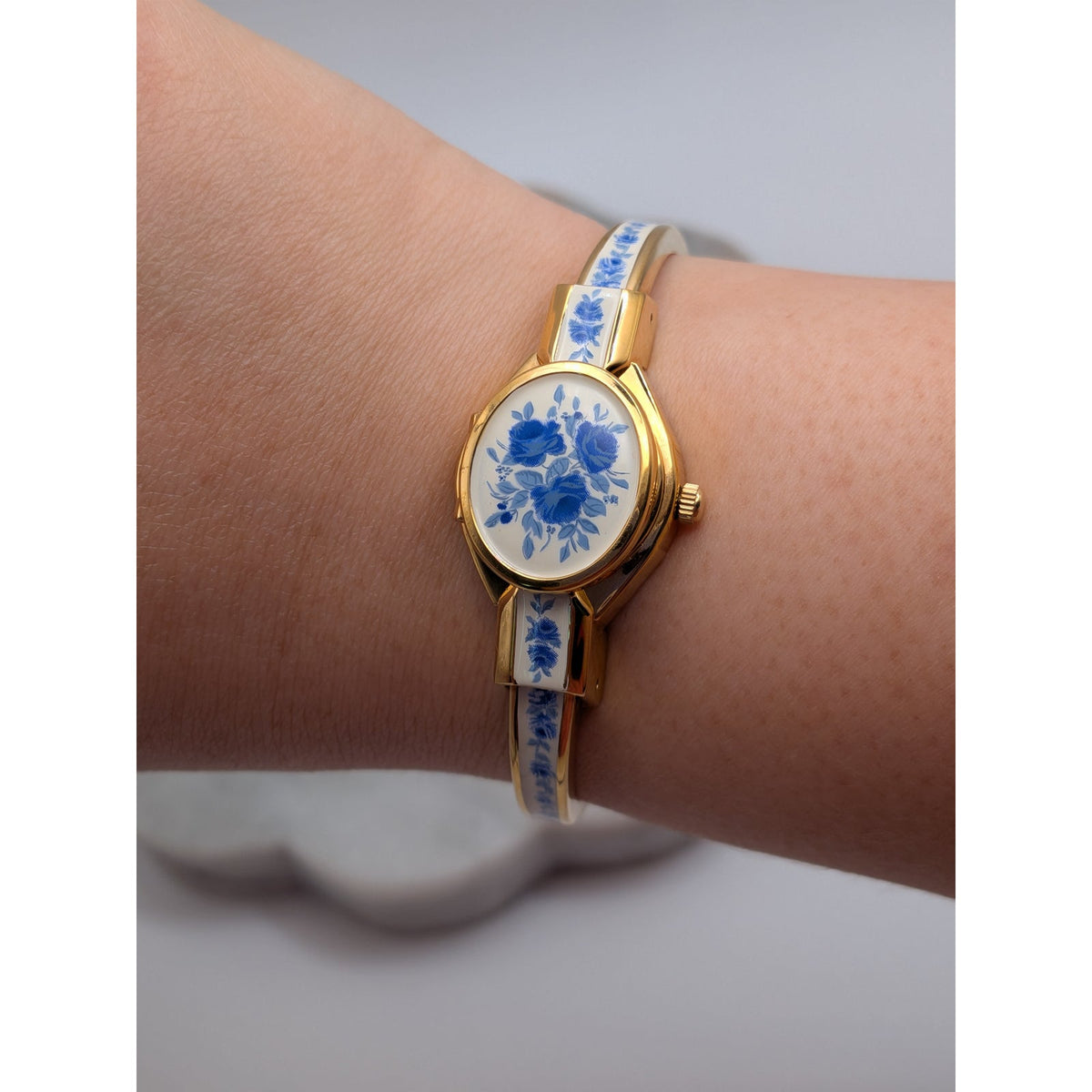 Andre Mouche Gold Tone Bangle Peekaboo Watch White Enamel Deep Blue Flowers