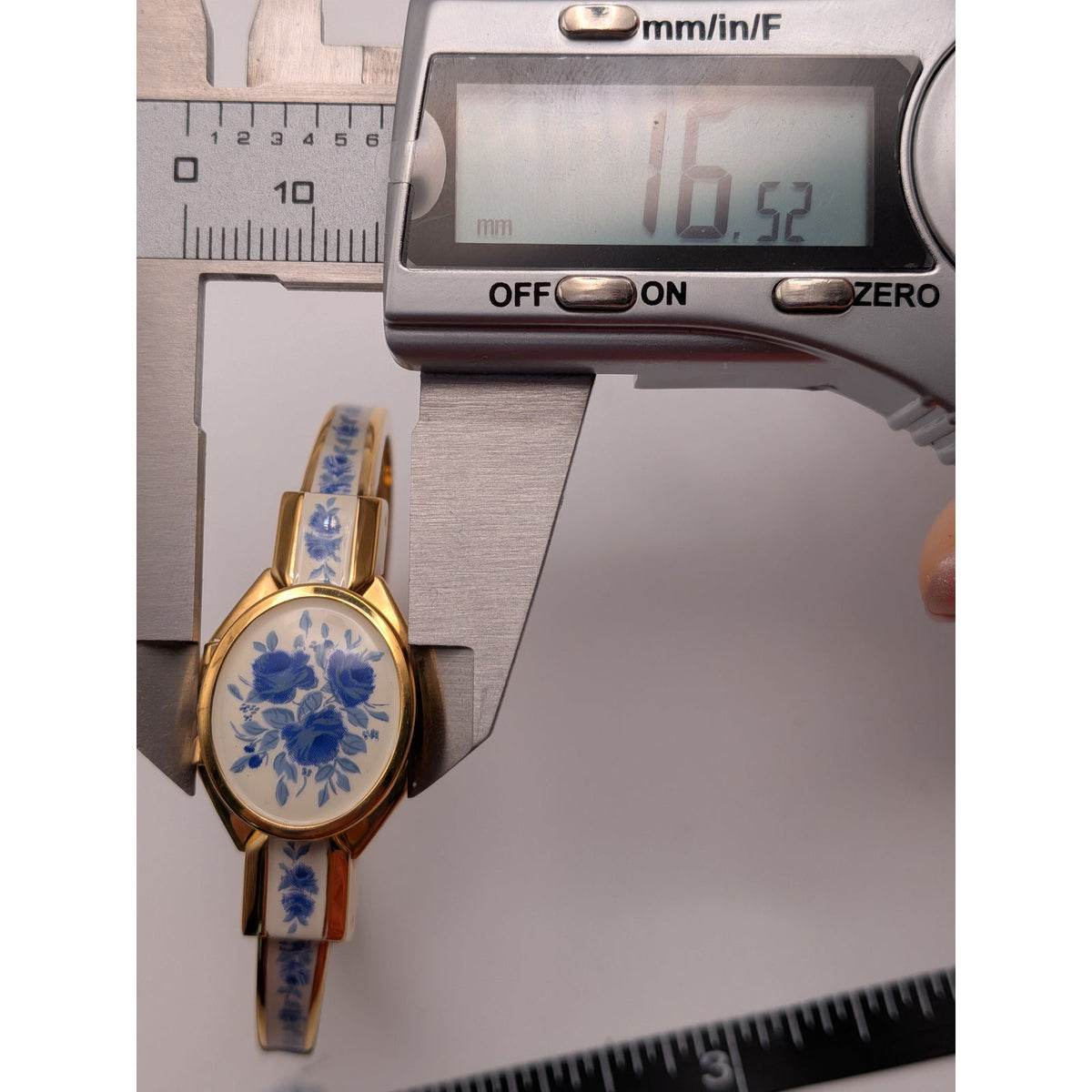 Andre Mouche Gold Tone Bangle Peekaboo Watch White Enamel Deep Blue Flowers