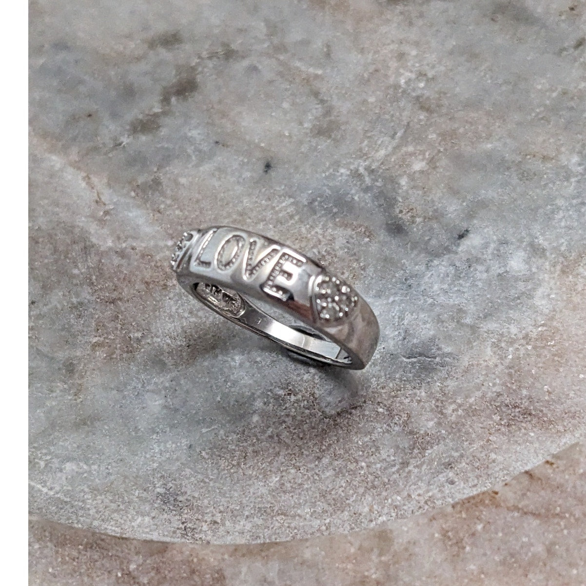 Preowned 10k White Gold "LOVE" Hearts Ring with 0.12ct Diamonds Size 6.75