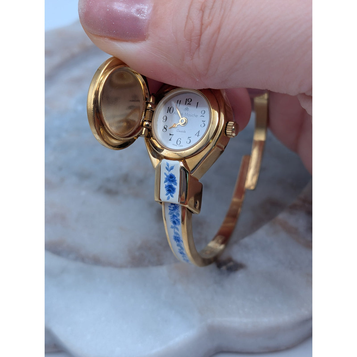Andre Mouche Gold Tone Bangle Peekaboo Watch White Enamel Deep Blue Flowers